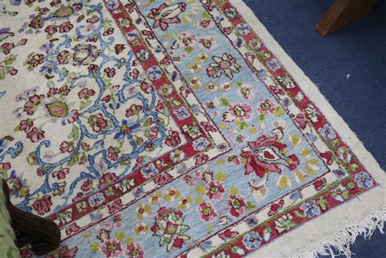 A Tabriz style cream ground carpet, woven with scattered flowers, 315 x 214cm